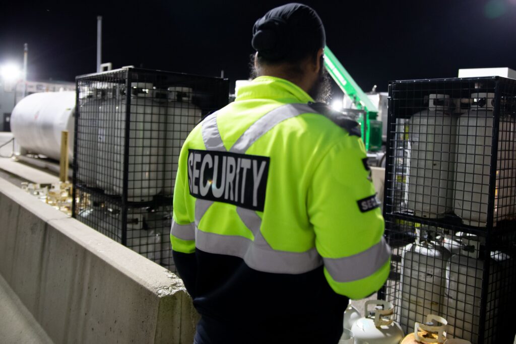 Vehicle patrol checking a warehouse perimeter during nighttime rounds