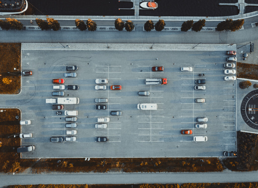 Aerial view of auto lot with security monitoring cameras installed