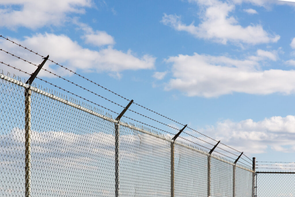 Perimeter security fencing with cameras at a California warehouse facility