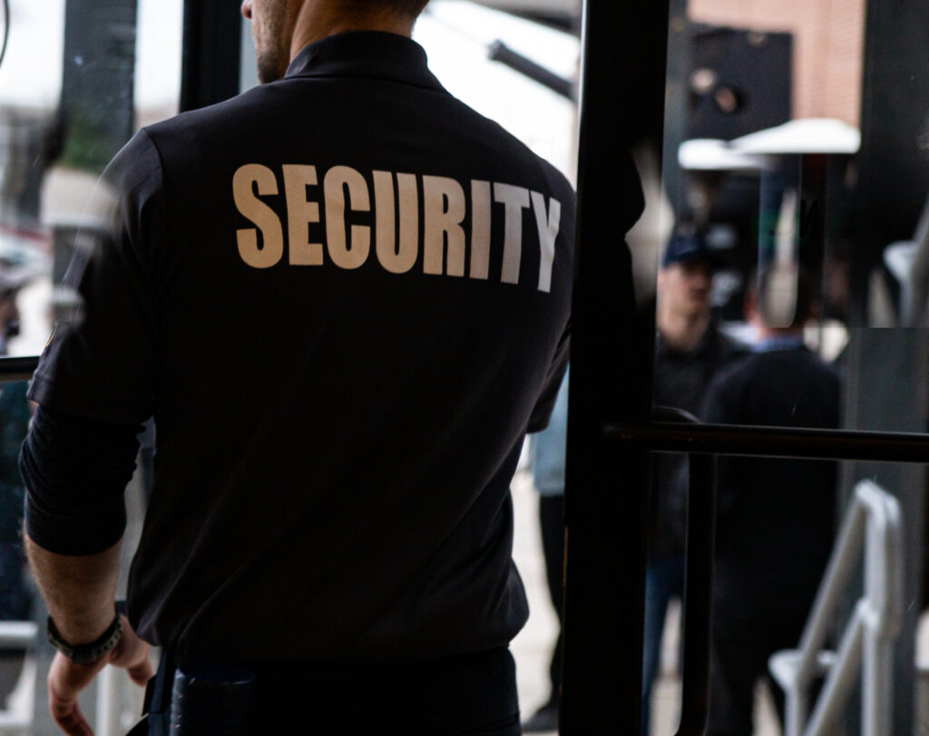 Uniformed security guard standing at retail store entrance